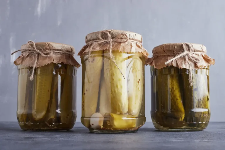 Fermented cucumbers in three jars tied with a bow