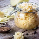 Traditional sauerkraut recipe ingredients ready to ferment on a wooden table