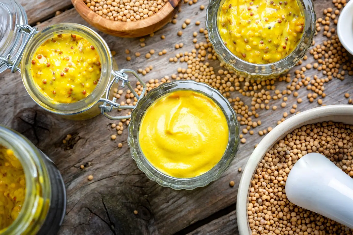 Homemade fermented mustard steps showcase on a wooden table